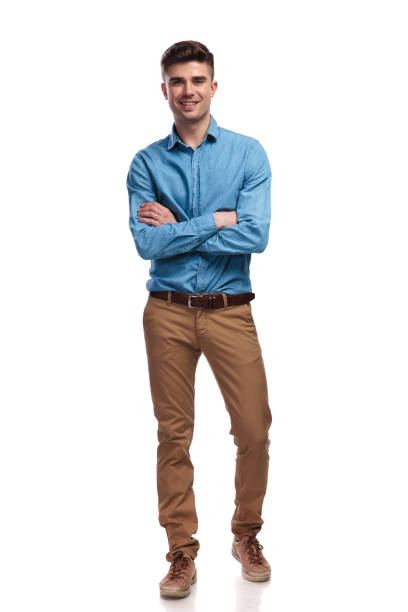 istock smiling young casual man standing with hands crossed 935996954
