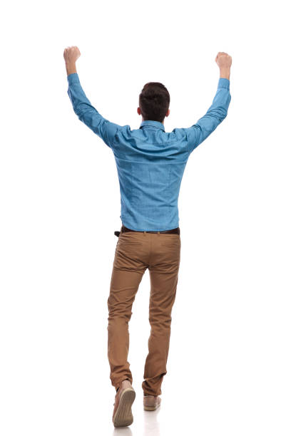 istock back view of a casual man celebrating success 935997480
