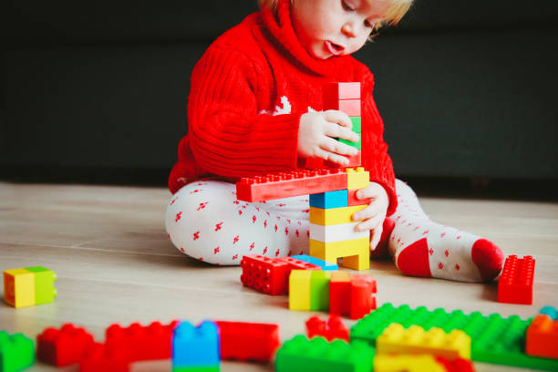 istock little baby playing with colorful plastic blocks 936000466