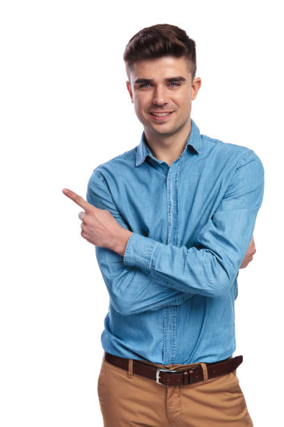istock smiling casual man with hands crossed is pointing to side 936000468