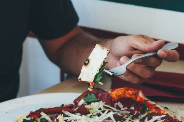 istock Man eating pizza in a restaurant 936000656