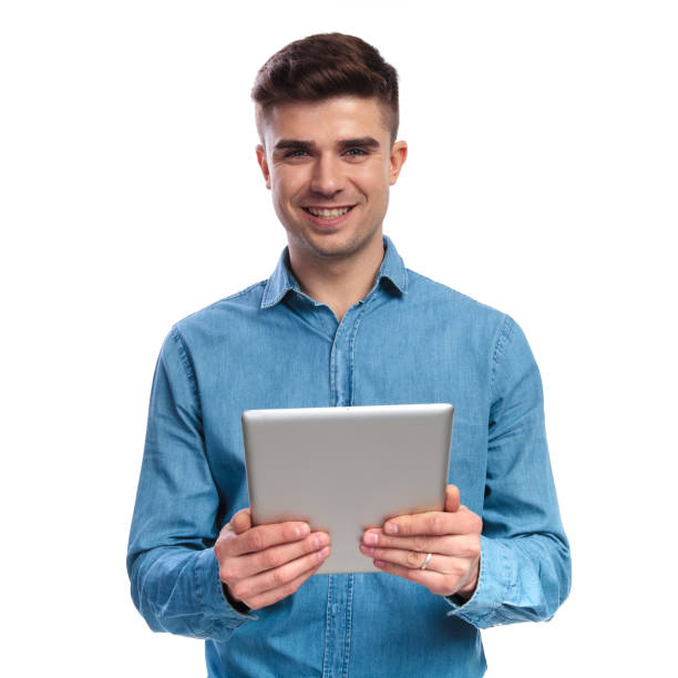 istock smiling young casual man holding a tablet 936000900