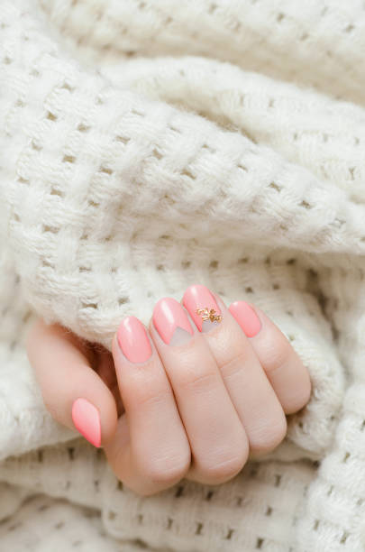 istock Female hands with light orange nail design 936004790