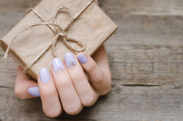 istock Female hands with light purple nail design 936004812