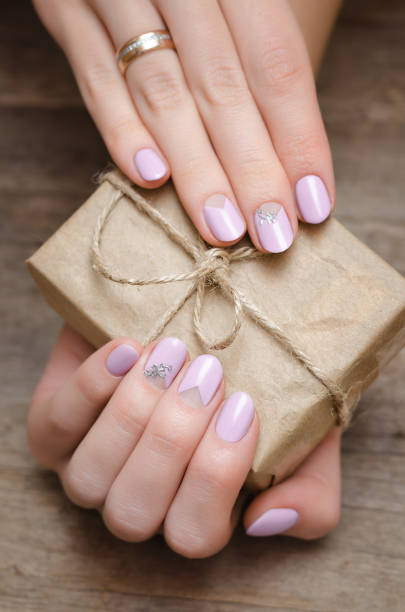 istock Female hands with light pink nail design 936005000