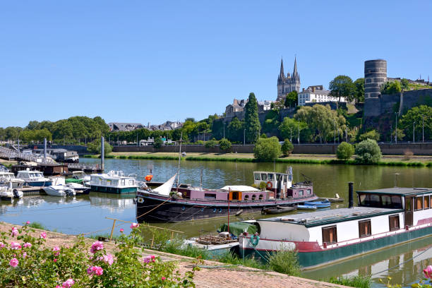 Port of Angers in France Port on the Maine river at Angers and the cathedral Saint Maurice. Angers is a commune in the Maine-et-Loire department, Pays de la Loire region, in western France about 300 km (190 mi) south-west of Paris houseboat photos stock pictures, royalty-free photos & images