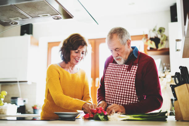 istock Senior couple preparing food in the kitchen. 936011394