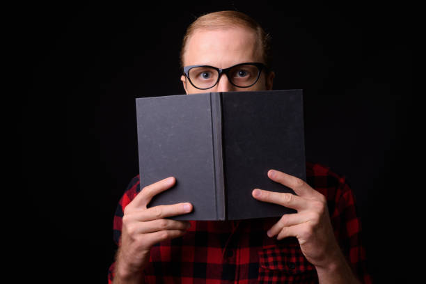Studio Portrait Of Man Against Black Background