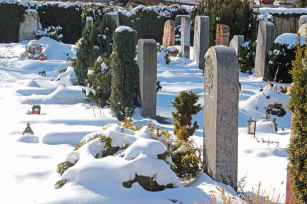 istock graveyard covered with snow on a sunny winter day 936012124
