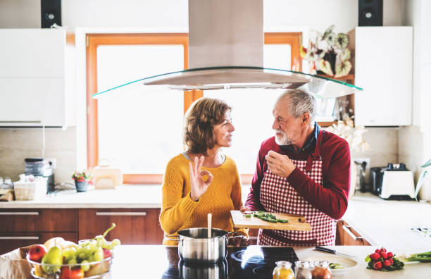 istock Senior couple preparing food in the kitchen. 936012194