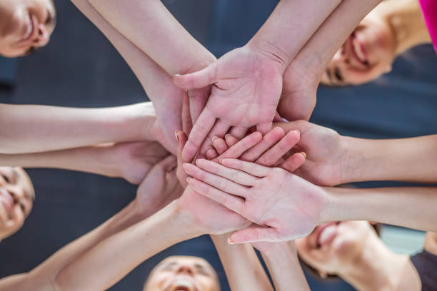 istock Super Teamwork. Multiracial Group of Friends with Hands in Stack. 936015558