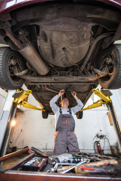 istock Male mechanic fixing broken car 936015604