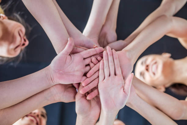 istock Super Teamwork. Multiracial Group of Friends with Hands in Stack. 936015612