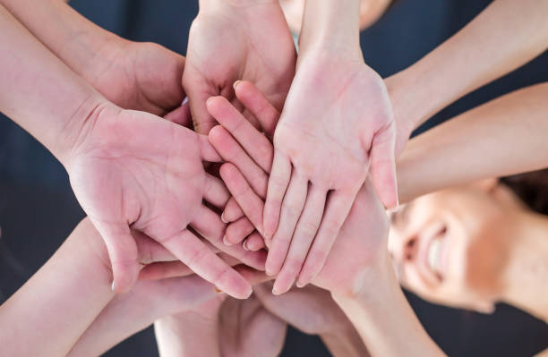 istock Super Teamwork. Multiracial Group of Friends with Hands in Stack. 936015734