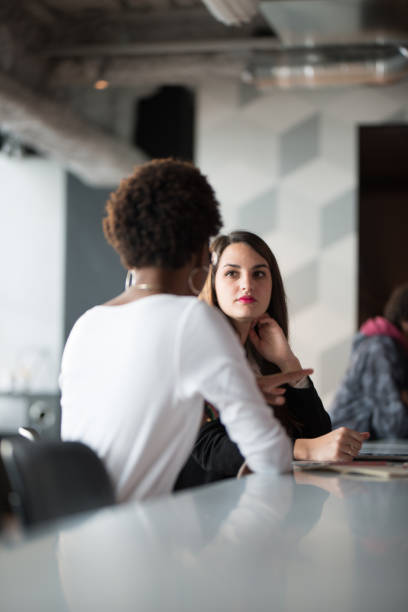 Various ethnic people working together in co-working space Various ethnic people working together in co-working space common room stock pictures, royalty-free photos & images