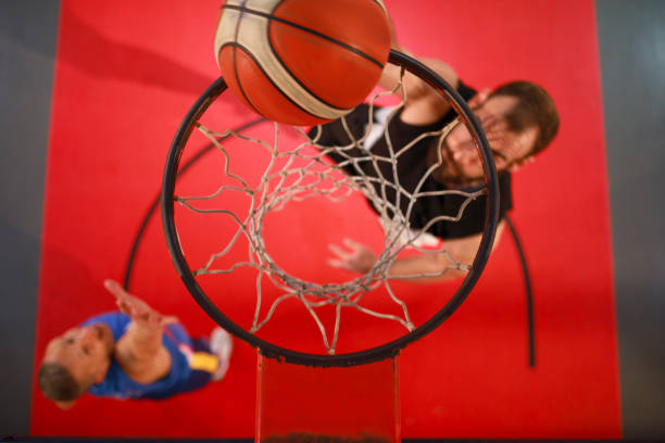 istock Two Friends Playing Basketball Basketball player makes slam dunk - Man Dunking 936045926