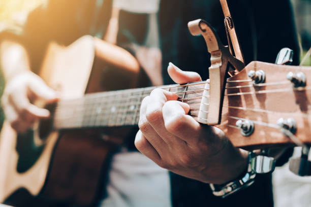 istock Asian man playing guitar and catch chord. 936075434