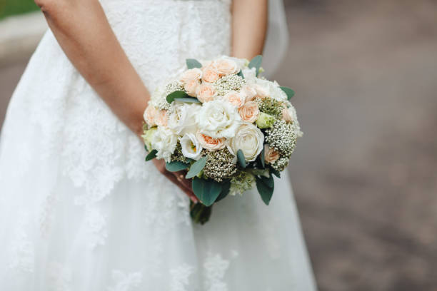 istock Beauty wedding bouquet in bride's hands, horizontal image, close-up 936082760