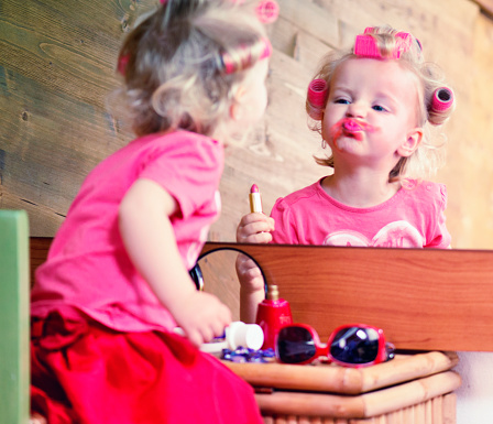 Little Girl with Hair Curlers and a Pink Lipstick