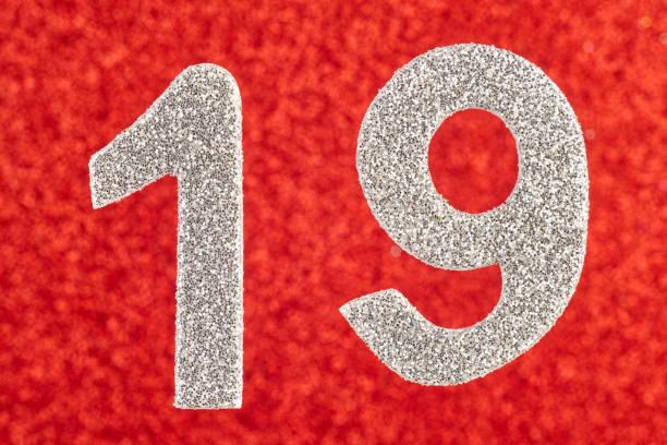 istock Number nineteen silver color over a red background. Anniversary. 936092850