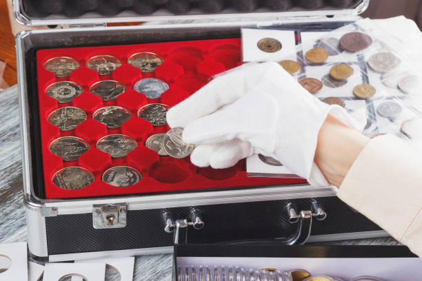 istock Hand in a glove with a silver coin 936093610