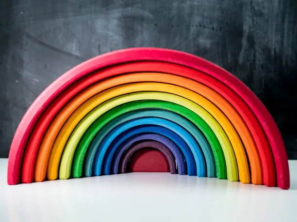 Rainbow wooden toy with chalkboard background