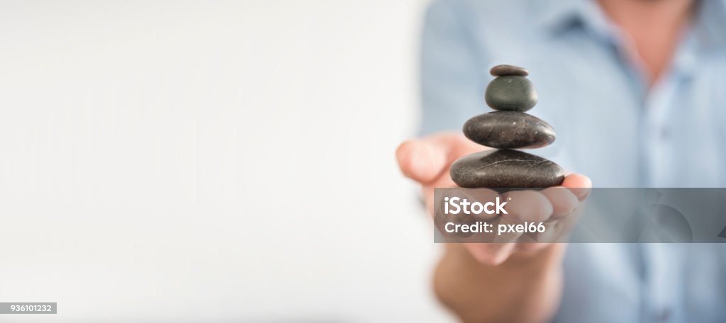 Find Balance Man balances stones in his hand Balance Stock Photo