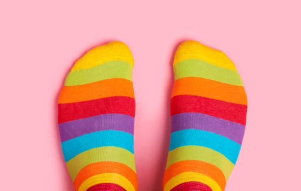 istock Foot in rainbow colors socks on pink background 936102430