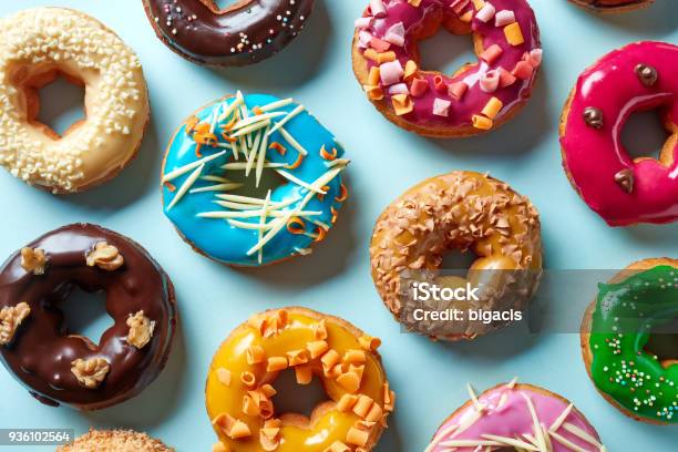 Various Donuts On Blue Background From Above Stock Photo - Download Image Now - Doughnut, Multi Colored, Food