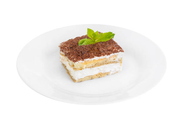istock Tiramisu with mint on a white plate isolated white 936106288