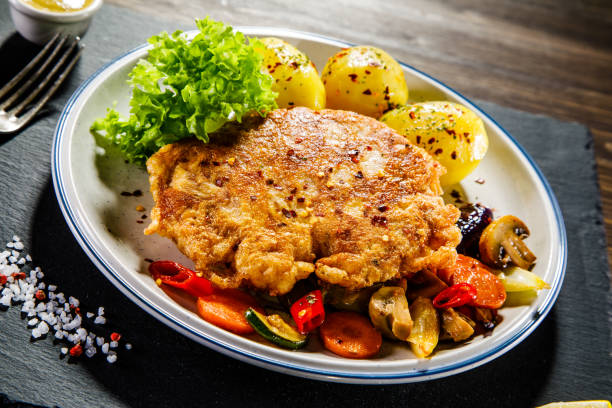 istock Fried pork chop, boiled potatoes and vegetables 936116714