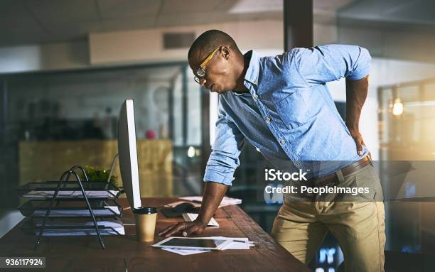 Paying The Highest Price For Success Stock Photo - Download Image Now - Backache, Pain, Rear View