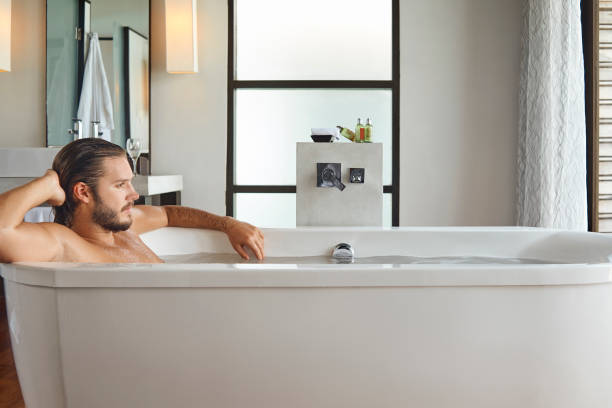 istock young handsome man enjoying in the bathtub 936120780