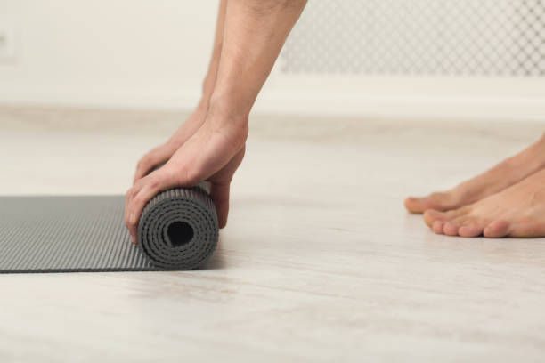 istock Rolling up fitness mat for exercise copy space 936121424