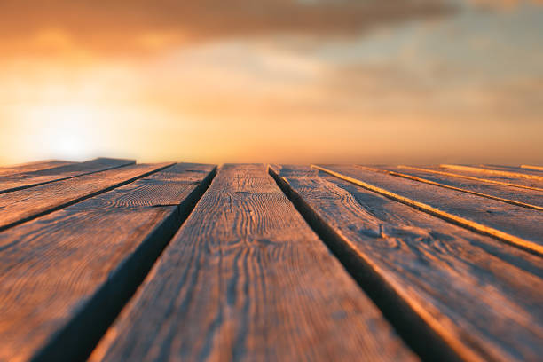 istock Close up top wooden table and blur sunset background 936121694
