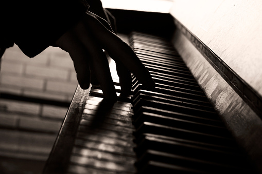 Musician playing on the old piano