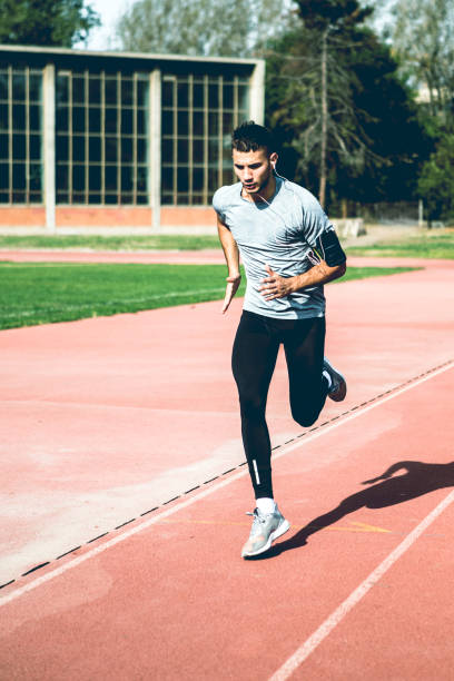 istock Sprinter running on sports tracks 936122330