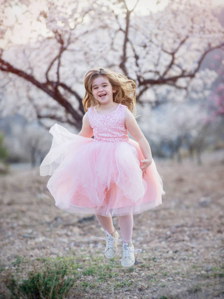 istock beautiful girl running through the spring park 936124830