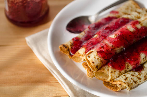 istock Hot pancakes in pile on a plate with a spoon poured with jam 936125562