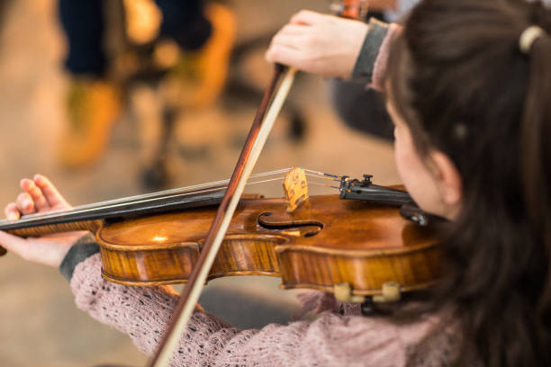 istock Little girl playing the violin 936129990