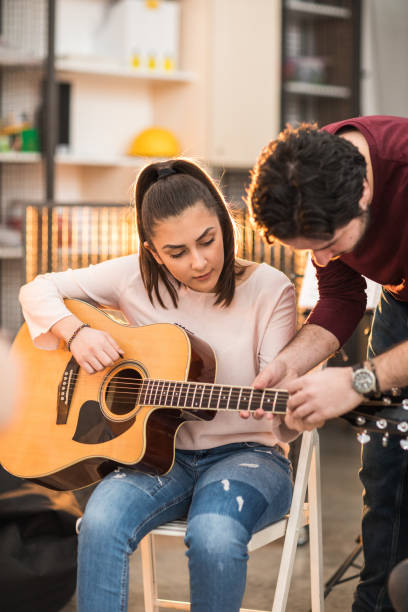 istock Young woman learning to play the guitar 936132164