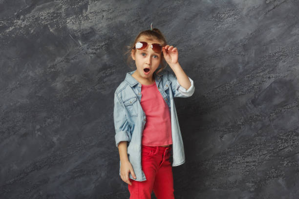 istock Happy little girl having fun at black studio background 936133018
