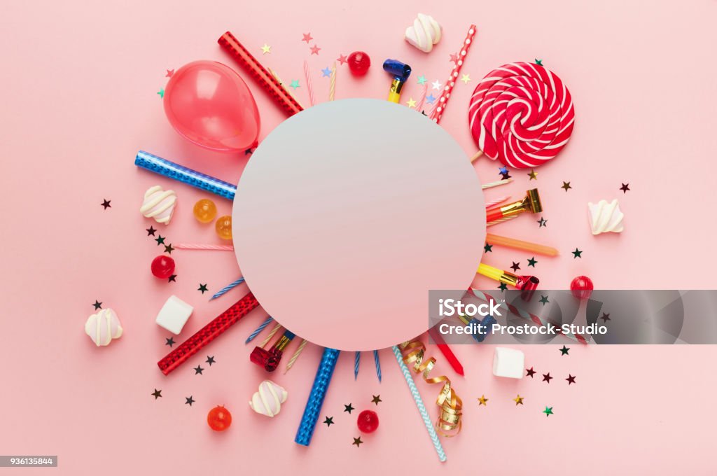 Children birthday party background Children birthday party background, frame with sweets, lollipops and confetti on pink background, copy space, top view Birthday Stock Photo