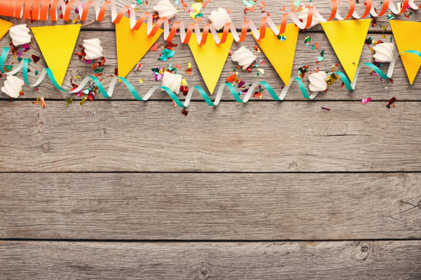 istock Colorful flags garland on wooden background 936136996