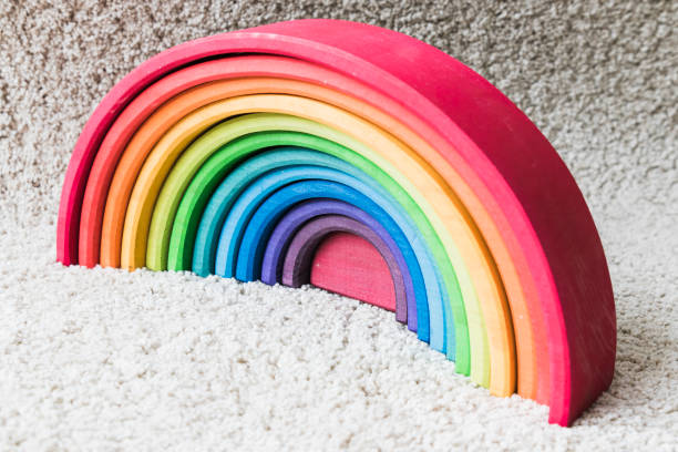 istock wooden waldorf rainbow on white carpet 936137070