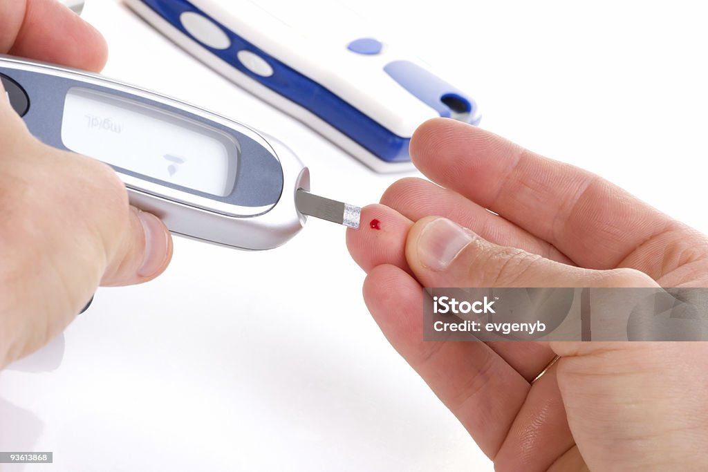 2 hands holding a glucose level blood test Diabetic is doing a glucose level finger blood test Diabetes Stock Photo
