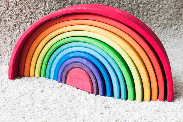 istock wooden waldorf rainbow on white carpet 936139266