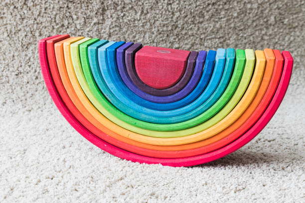 istock wooden waldorf rainbow on white carpet 936139626