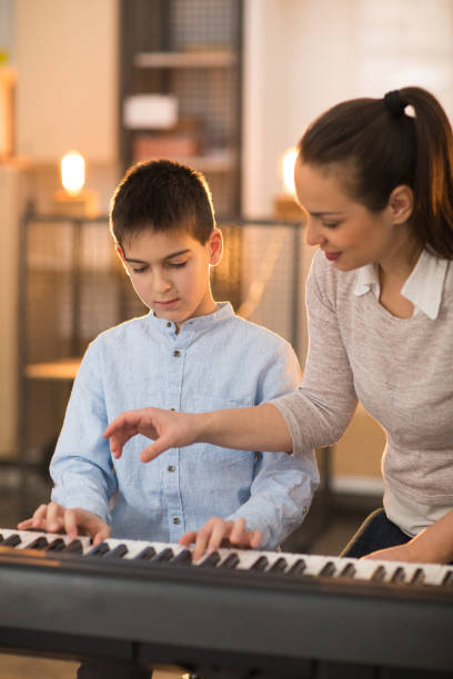 istock Learning to play the piano 936139860