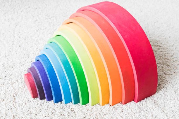 istock wooden waldorf rainbow on white carpet 936139980